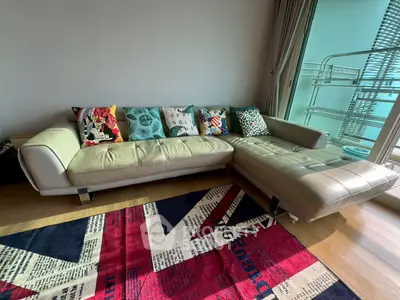 Stylish living room with modern sofa and vibrant rug, perfect for urban living.