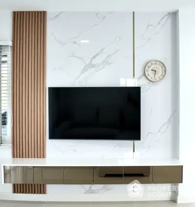 Modern living room with sleek wall-mounted TV and stylish marble accent wall