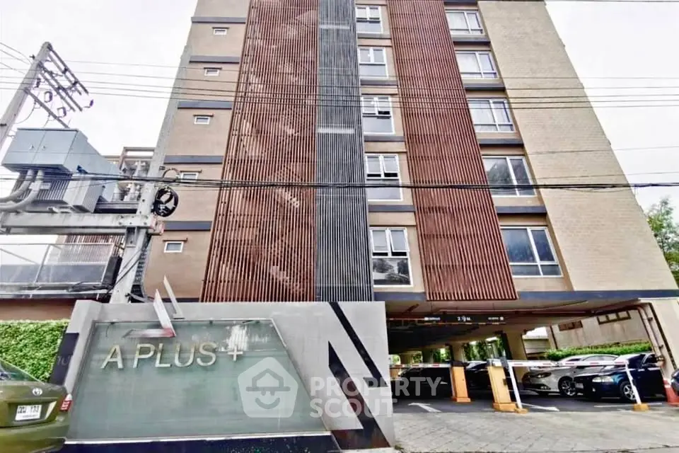 Modern apartment building with parking area and stylish facade design.