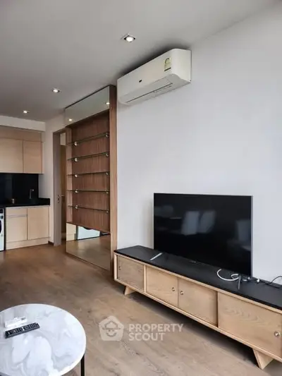 Modern living room with sleek TV setup and stylish wooden furniture