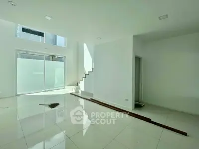 Spacious modern living room with high ceilings and natural light