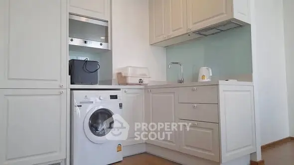 Modern kitchen with washing machine and sleek cabinetry
