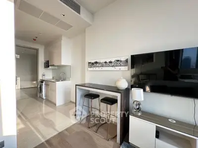 Modern open-plan living room with sleek kitchen and stylish decor