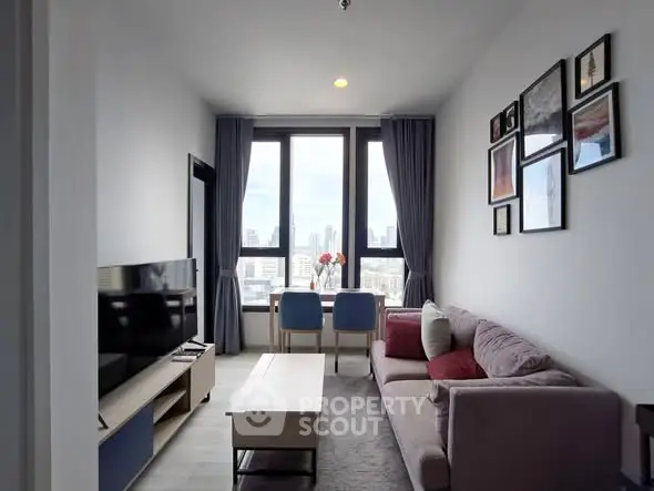 Modern living room with city view, stylish decor, and natural light.
