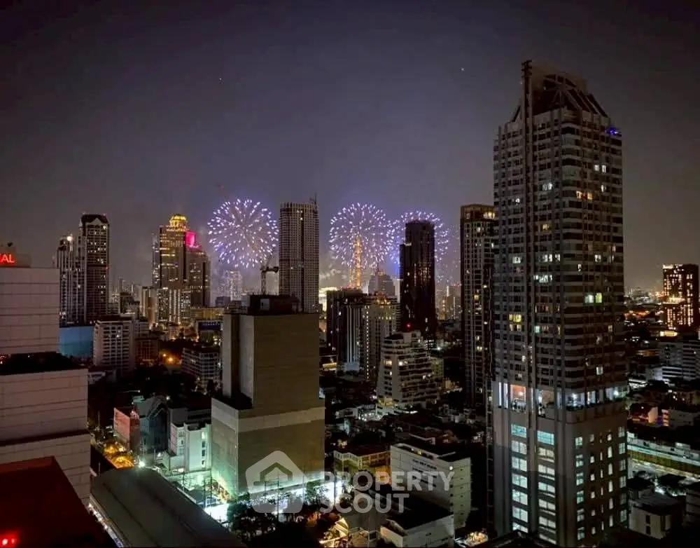 Stunning city skyline view with vibrant fireworks illuminating the night sky, showcasing urban living at its finest.