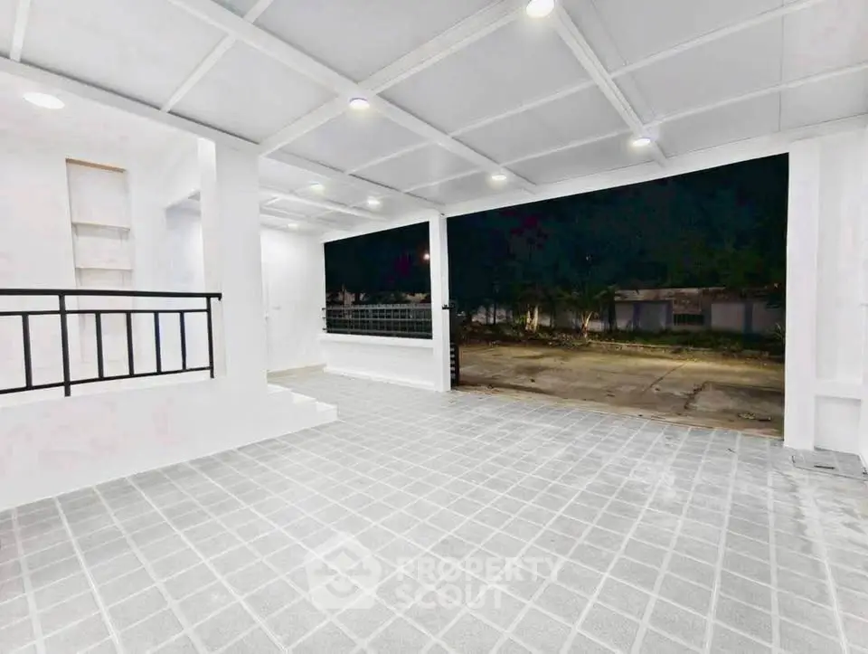 Spacious modern garage with tiled flooring and open view, perfect for multiple vehicles.