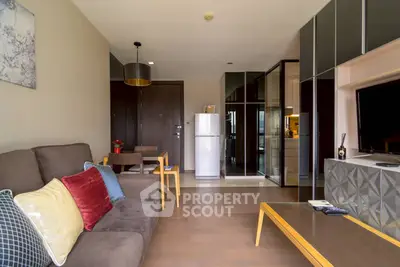 Modern living room with stylish decor and open layout, featuring a cozy sofa and sleek furniture.