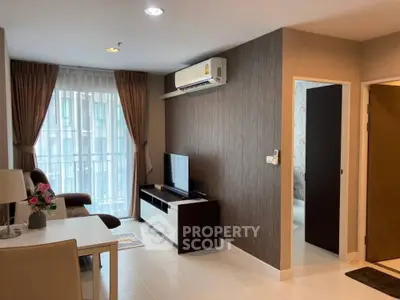 Modern living room with stylish decor and natural light in a cozy apartment setting.