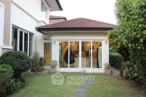Charming suburban home with lush garden and modern glass doors, perfect for family living.