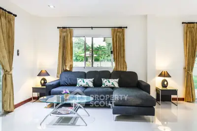 Spacious living room with elegant decor and large window view