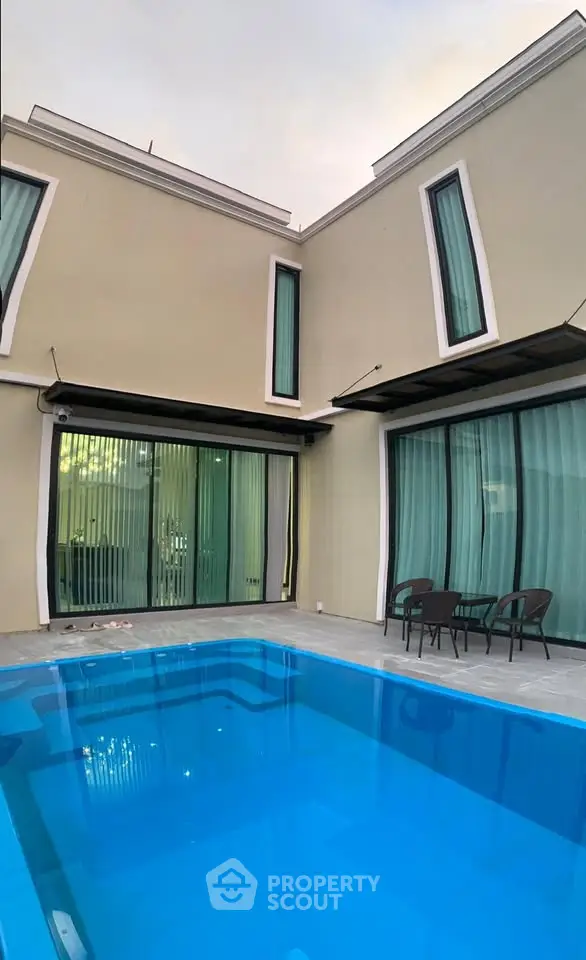 Modern two-story house with private pool and stylish patio area.