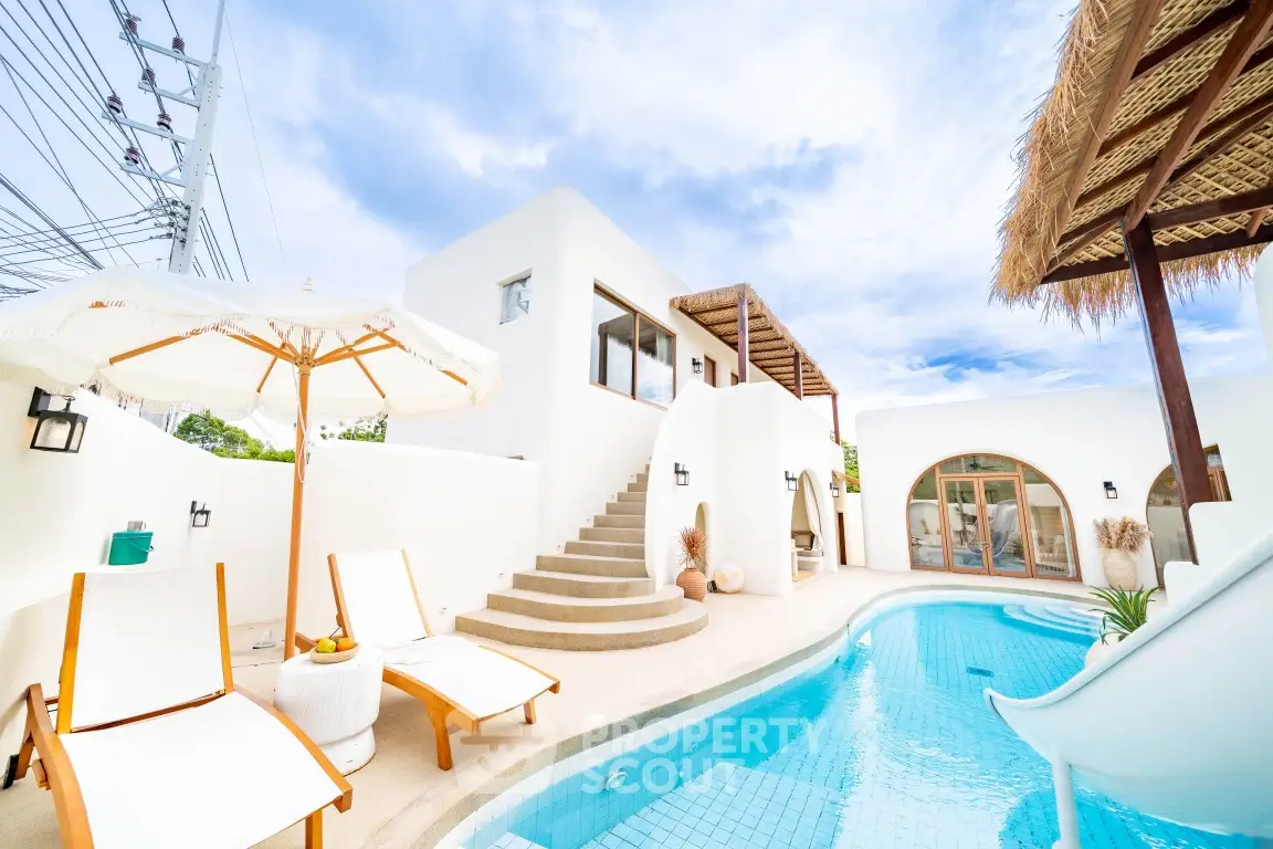 Luxurious Mediterranean-style villa with private pool and sun loungers, perfect for relaxation and leisure.