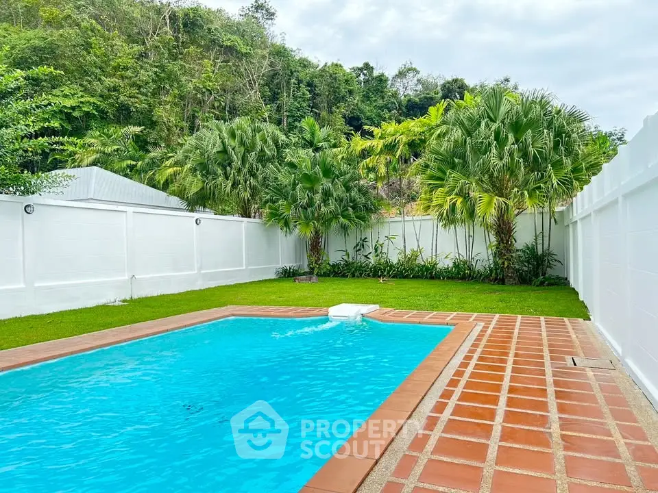 Stunning private pool with lush greenery and spacious patio in serene backyard setting.