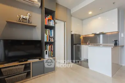 Modern open-layout living room with sleek kitchen and stylish decor