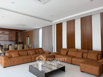 Spacious modern living room with elegant brown sofas and marble coffee table