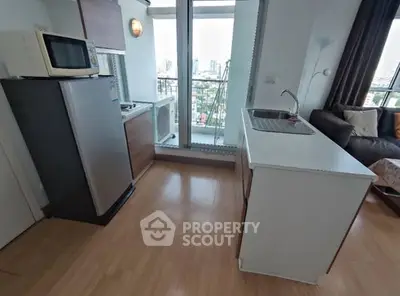 Modern kitchen with city view, featuring sleek appliances and open layout.