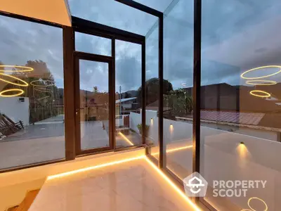 Stunning modern balcony with glass walls and ambient lighting offering breathtaking views