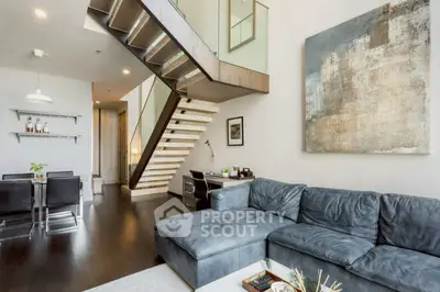 Modern living room with sleek staircase and stylish decor