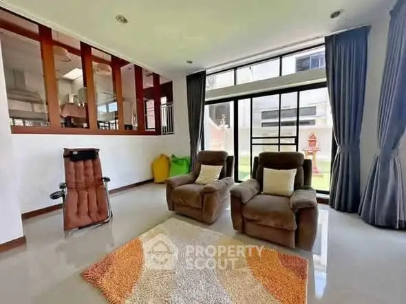 Spacious living room with plush seating and large windows for natural light.