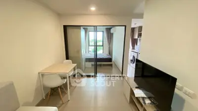 Modern studio apartment with glass partition, cozy dining area, and natural light.