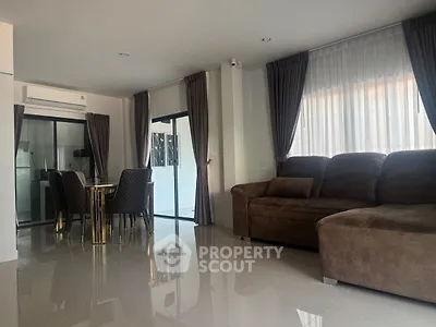 Spacious modern living room with plush sofa and elegant dining area