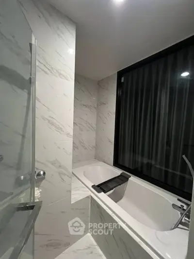 Luxurious bathroom with modern bathtub and elegant marble tiles