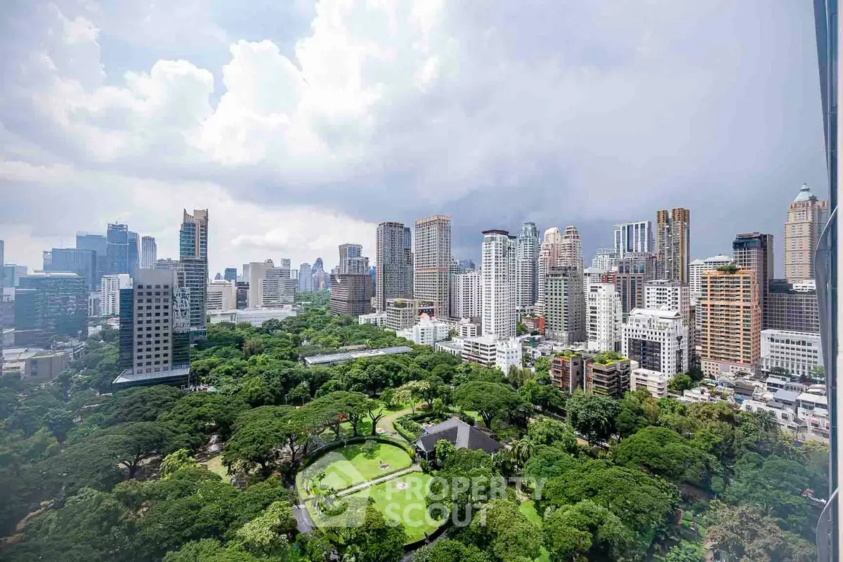 Stunning cityscape view with lush greenery and towering skyscrapers under a dramatic sky.
