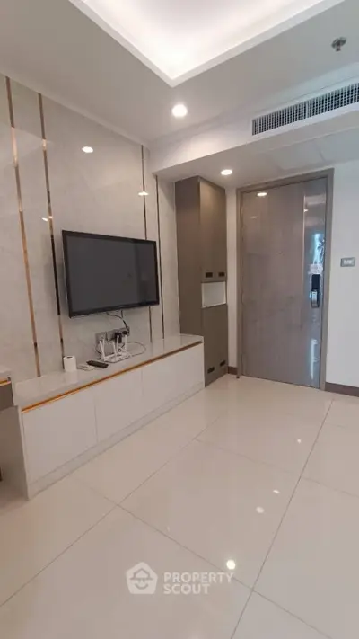 Modern living room with sleek TV setup and elegant marble accents