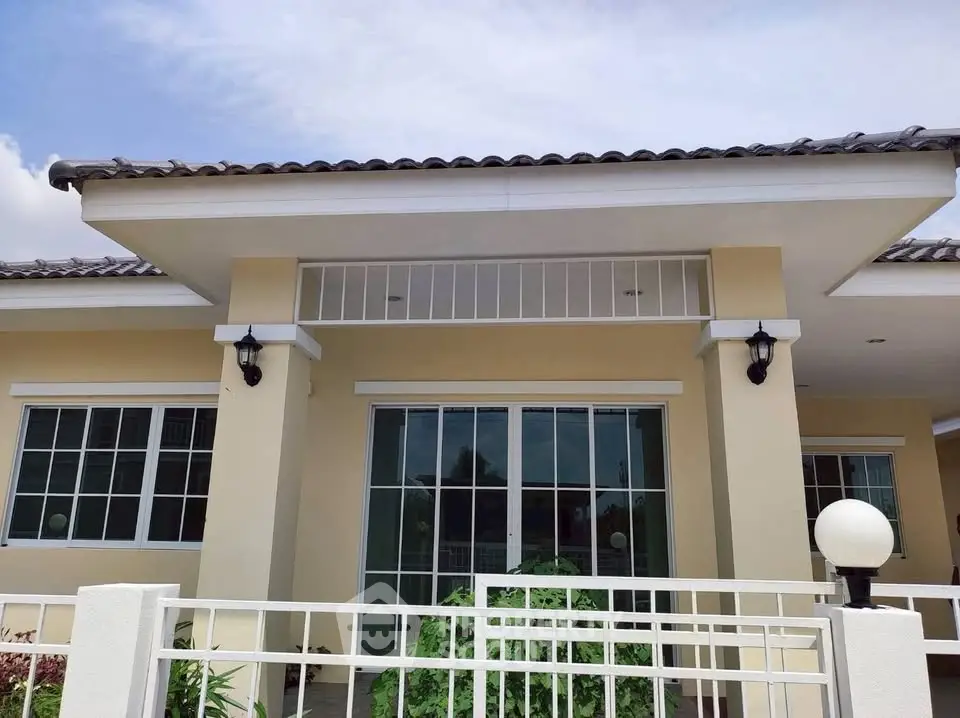 Charming single-story home with modern facade and large windows.