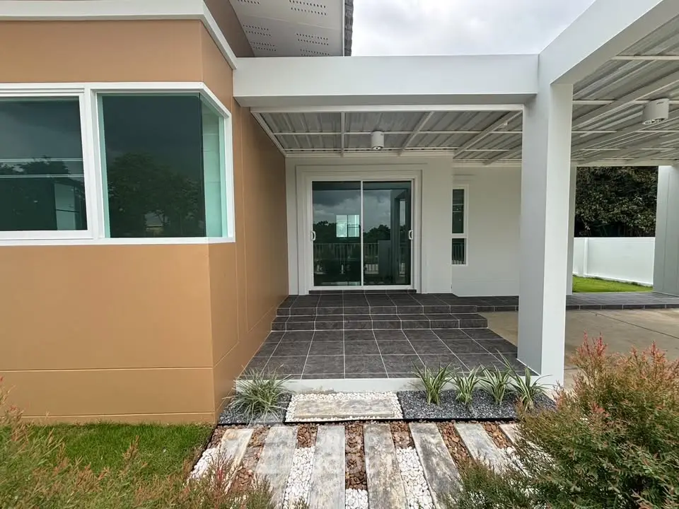 Modern home entrance with sleek design and landscaped pathway