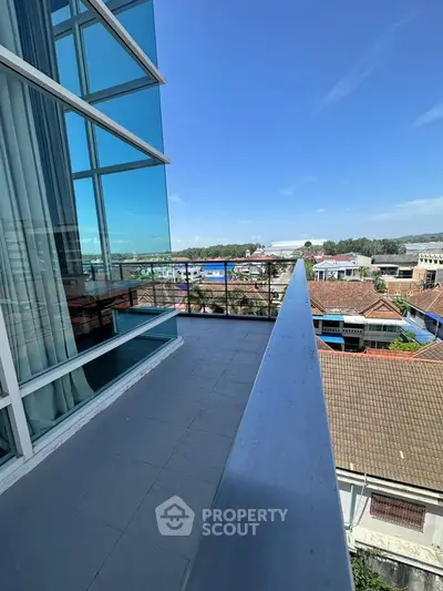 Modern balcony with glass railing offering panoramic city views