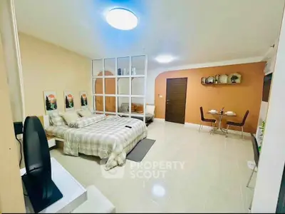 Spacious modern bedroom with cozy dining area and stylish decor