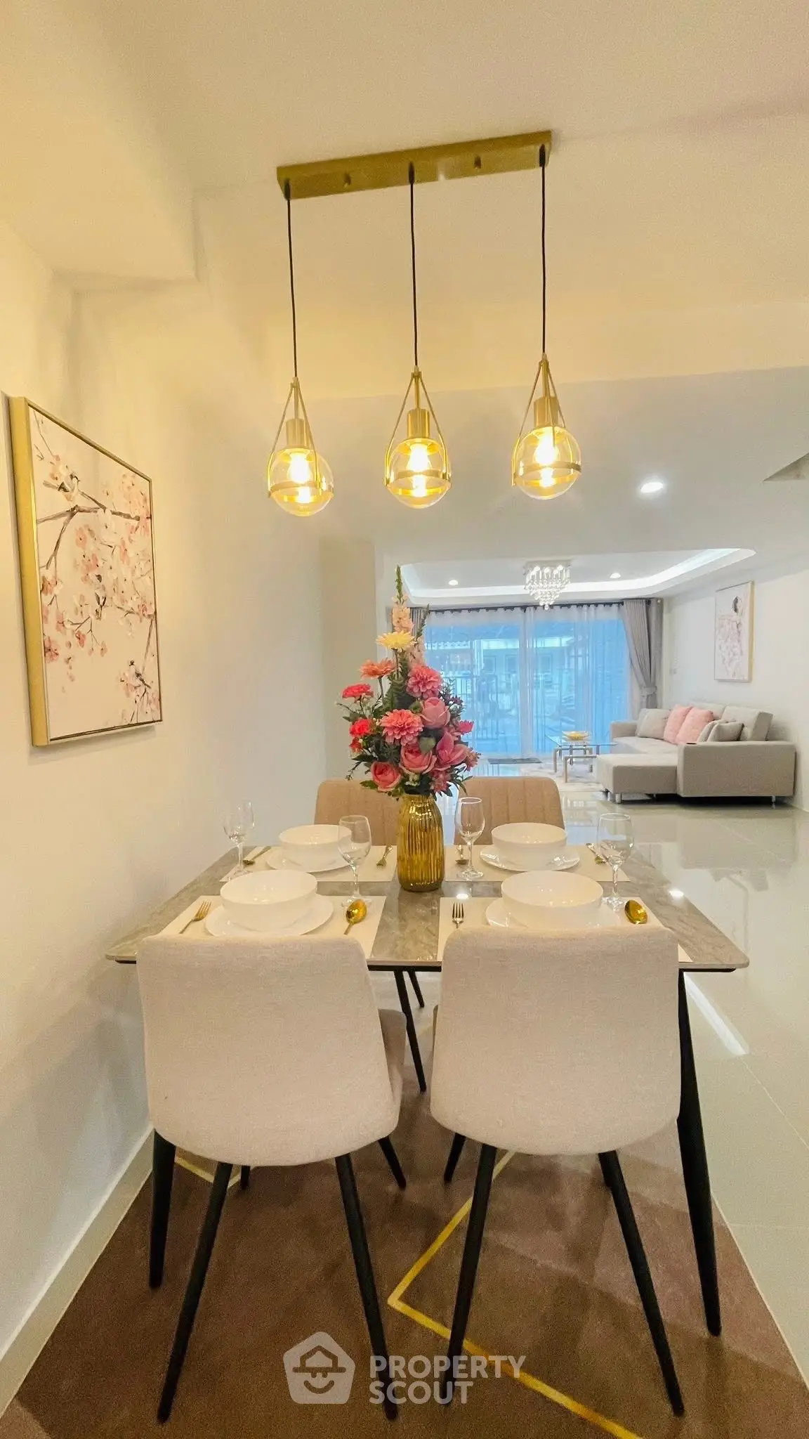 Elegant dining area with modern lighting and stylish decor in a contemporary apartment.
