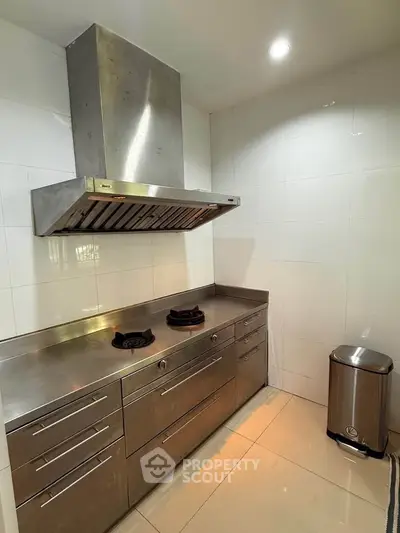 Modern kitchen with stainless steel appliances and sleek cabinetry, perfect for culinary enthusiasts.
