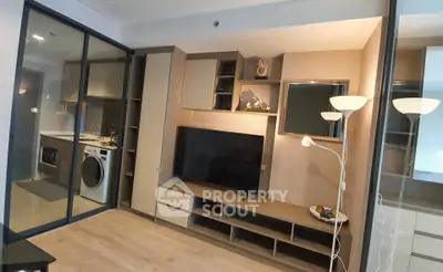 Modern living room with sleek TV unit and glass partitioned laundry area