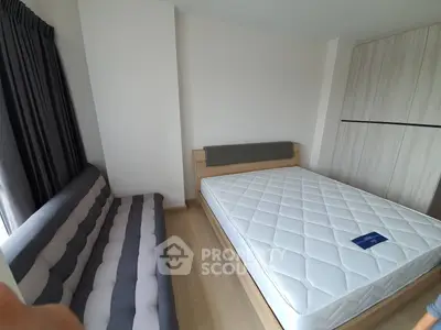 Modern bedroom with stylish bed and cozy sofa in a bright apartment