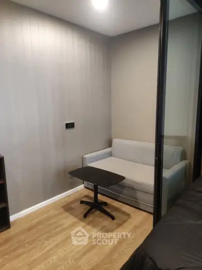 Cozy small living area with modern sofa and table, perfect for compact spaces.