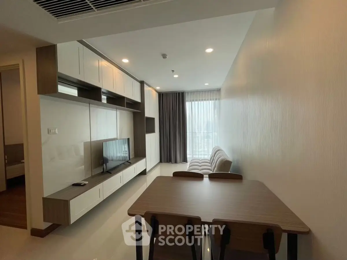 Modern living room with sleek furniture and natural light, perfect for urban living.