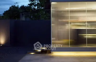 Modern exterior with sleek glass facade and ambient lighting