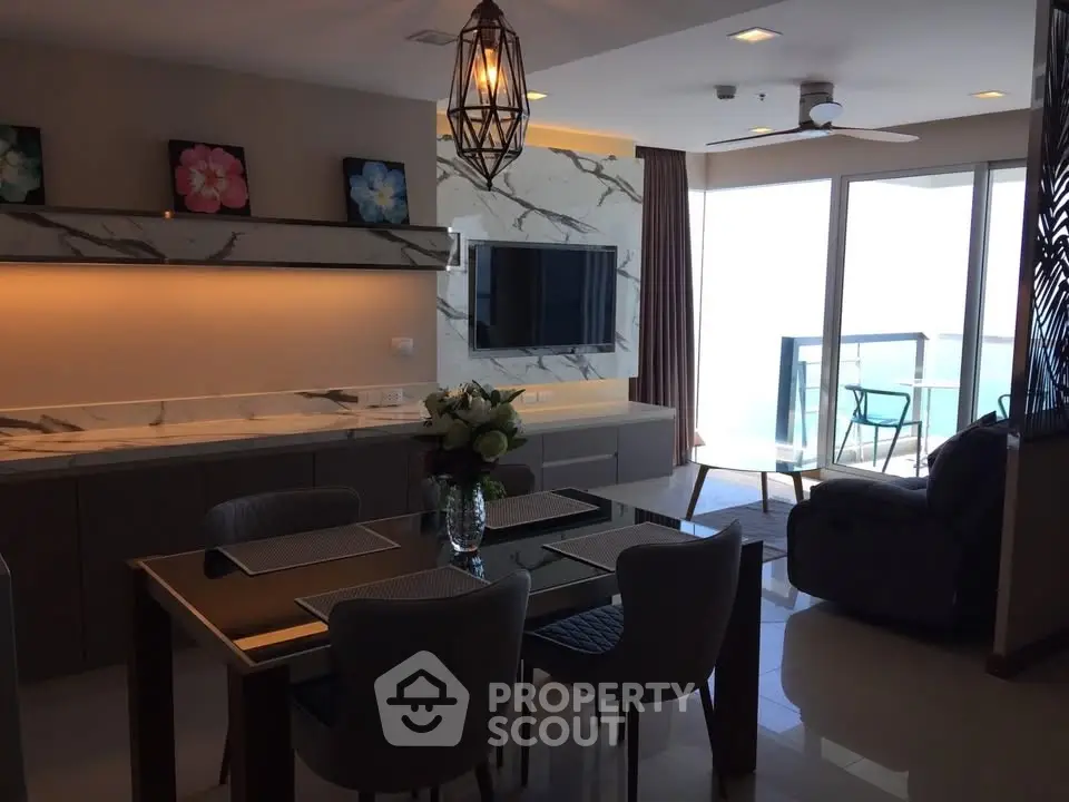 Luxurious modern living room with elegant dining area and stunning balcony view.