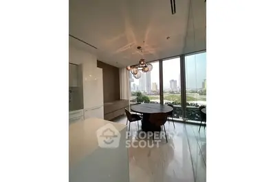 Modern dining area with city view, elegant lighting, and sleek design.