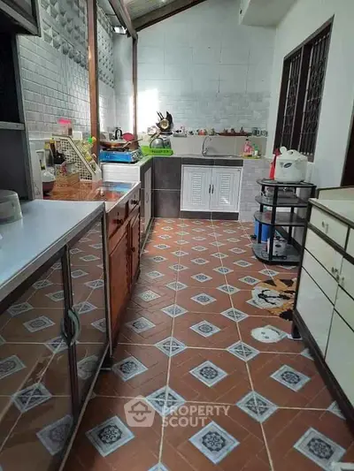 Charming kitchen with unique tile flooring and ample storage space, perfect for culinary enthusiasts.