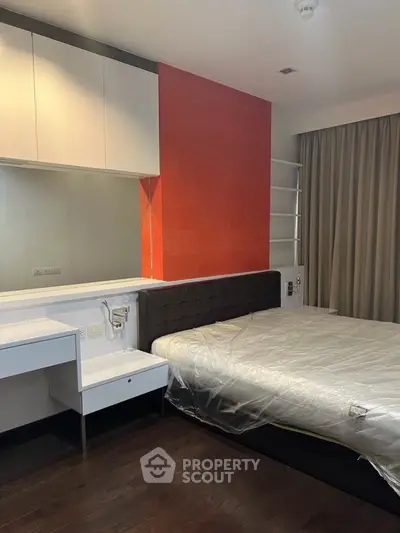 Modern bedroom with sleek design and vibrant accent wall