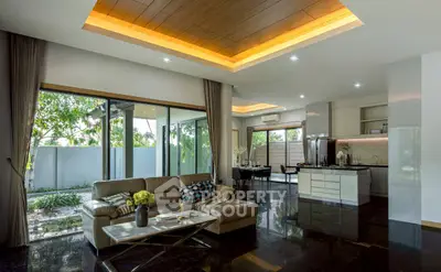 Luxurious open-plan living room with modern kitchen and garden view