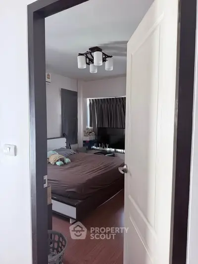 Cozy bedroom with modern lighting and wooden flooring