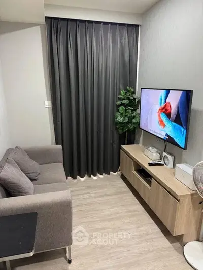 Cozy living room with modern decor and flat-screen TV, perfect for relaxation.