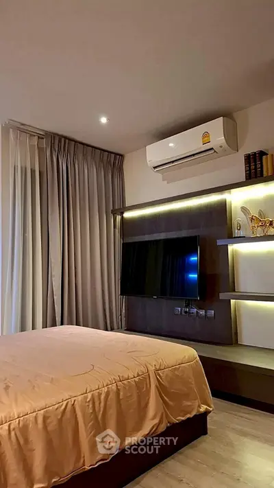 Modern bedroom with sleek design, featuring a wall-mounted TV and ambient lighting.