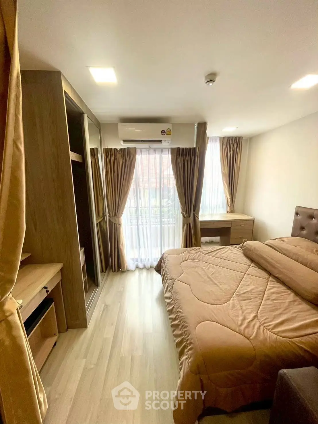 Cozy bedroom with modern furnishings and large window for natural light