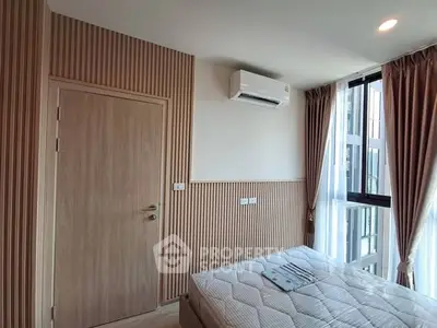 Modern bedroom with air conditioning and large windows in a stylish apartment.