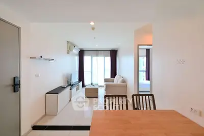 Modern living room with sleek furniture and natural light in a stylish apartment.